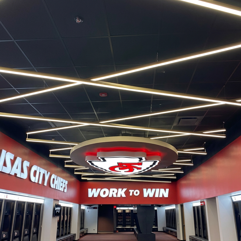 Stadium corridor with linear LED ceiling lighting and illuminated team branding